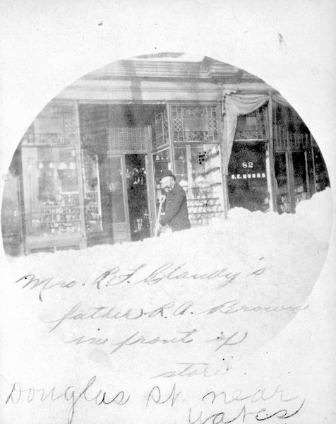 Robert Austen Brown shovelling snow outside businesses on Douglas Street near Yates, Victoria. 